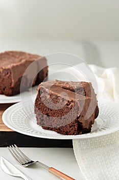 Fresh homemade chocolate sponge cake on wooden board