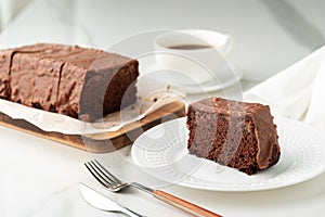 Fresh homemade chocolate sponge cake on wooden board