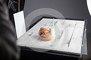 fresh homemade cinnamon rolls on a wooden white desk and milk in glass bottle