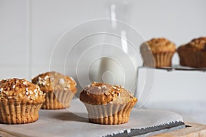 Fresh homemade delicious carrot muffins decorated with oat flakes and brown sugar on rustic table