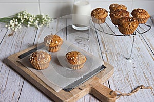 Fresh homemade delicious carrot muffins decorated with oat flakes and brown sugar on rustic table