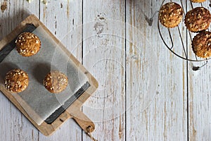 Fresh homemade delicious carrot muffins decorated with oat flakes and brown sugar on rustic table