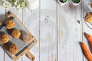 Fresh homemade delicious carrot muffins decorated with oat flakes and brown sugar on rustic table