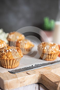 Fresh homemade delicious carrot muffins decorated with oat flakes and brown sugar on rustic table