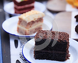 Fresh Homemade Delicious Multilayered Chocolate Cake decorated with chocolate sprinkles or chocolate jimmies. Food Catering, photo