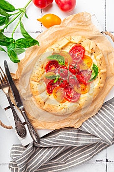 Fresh homemade galette with tomatoes, ricotta cheese and basil