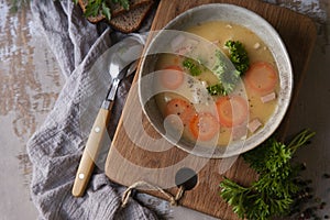 Fresh homemade made split pea soup with fresh parsley in country rustic kitchen, flat lay, copy space