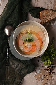 Fresh homemade made split pea soup on grey background and dark green kitchen cloth