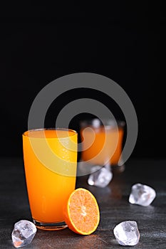 Fresh homemade orange juice in glass with ice on vintage wooden table. Freshness beverage fruit for healthy and diet with top copy