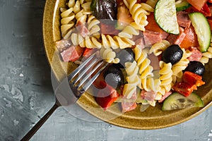 Fresh homemade pasta salad with tomatoes, olive and pepper