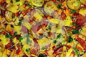 Fresh homemade pizza with sausage, cheese and pickles top view close-up, texture, background