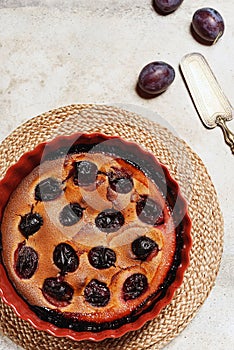 Fresh homemade plum pie in ceramic form