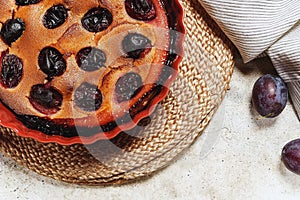 Fresh homemade plum pie in ceramic form