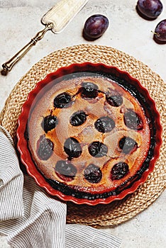 Fresh homemade plum pie in ceramic form