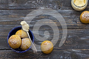 Fresh homemade pumpkin cardamom buns yeast-free with cream sprinkled with icing sugar on wooden board