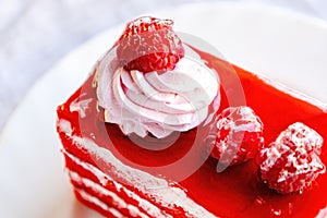 Fresh homemade Red Velvet cake decorated with whipped cream and raspberry berries