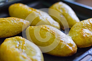 Fresh, homemade rustic meat pies on the baking sheet