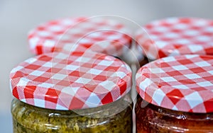 Fresh homemade sauces or marinades in jars for sale at the farmers market