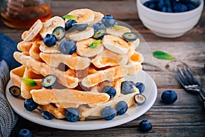 Fresh homemade waffles with blueberries and banana for breakfast