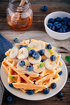 Fresh homemade waffles with blueberries and banana for breakfast