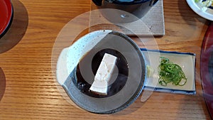 Fresh homemade white tofu boiling dip in yuzu soy sauce Kaizen traditional Japanese meal