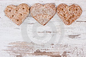 Fresh homemade wholegrain bread in shape of heart for breakfast. Copy space for text on old rustic background