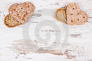 Fresh homemade wholegrain bread in shape of heart for breakfast. Copy space for text on old rustic background