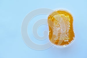 fresh honey with comp in a jar on white background