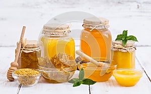 Fresh honey in the jars, with honeycomb and bee pollen