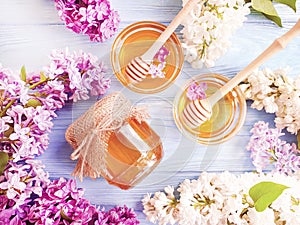 Fresh honey natural healthy spring heather lilac compositionon wooden background