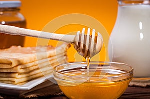 Fresh honey with a Stack of blinis or crepes