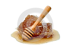 Fresh Honeycomb slice and wooden honey dipper isolated on white background