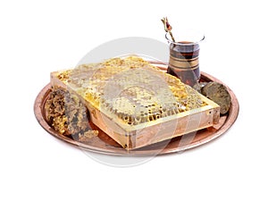 Fresh honeycombs with honey on plate ,cup of Turkish tea