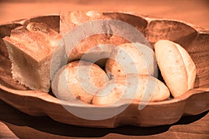 Fresh and hot breads put in a wooden basket.