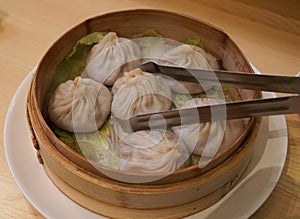 Fresh and hot dumplings in bamboo steamer