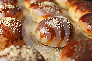 Fresh hot sweet buns with sesame seeds from the oven, homemade bakery