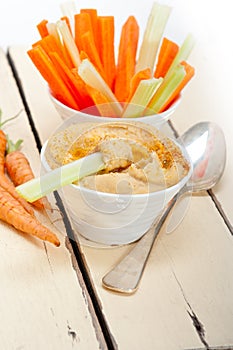 Fresh hummus dip with raw carrot and celery