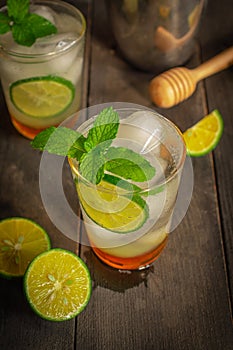 Fresh Ice Honey Lemon soda drink on the wood table there are same object,  lemon slice, cocktail shaker and wooden honey dipper