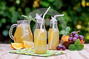 Fresh iced drinks with grapes and orange