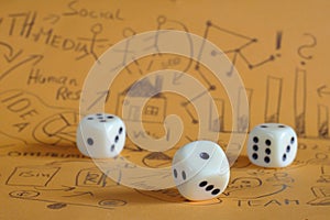 Fresh ideas, innovation and risks in business, concept with business scribble and dices. Close up shot with focus on foreground