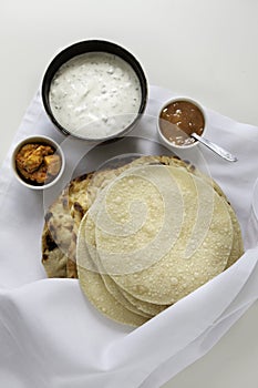 Fresh Indian flat breads Naans and poppadums served on the white cloth photo