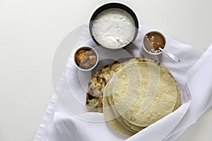 Fresh Indian flat breads Naans and poppadums served on the white cloth photo