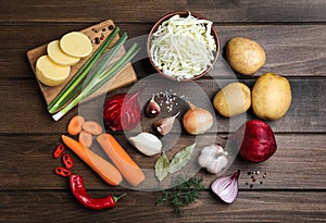 Fresh ingredients for borscht on wooden table, flat lay