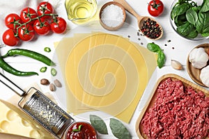 Fresh ingredients for lasagna on wooden table, flat lay