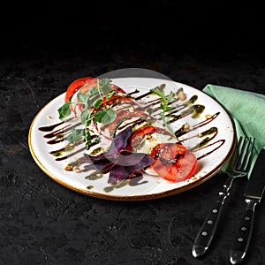 Fresh italian caprese salad with Mozzarella cheese with tomato, Pesto and balsamic sauce. photo for the menu.