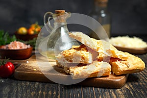 Fresh Italian focaccia bread close up on Durk table photo