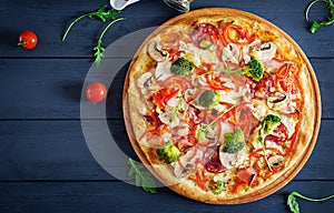 Fresh italian pizza with chicken fillet, mushrooms, ham, salami
