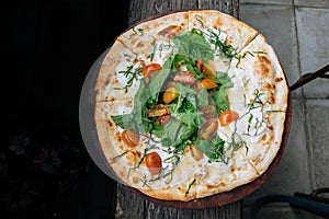 Fresh italian pizza with tomatoes, cheese, basil on black wooden background. Copy space. Homemade with love. Fast