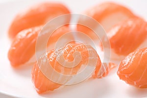 Fresh japanese salmon sushi in plate on white background