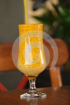Fresh juice in the glasse on wooden table,selective focus,hawai juice, coctail juice